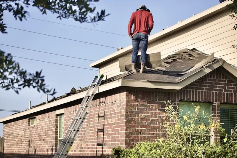 Professional roofer working on a residential roof in Englesville